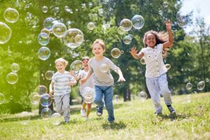 kids having fun chasing bubbles